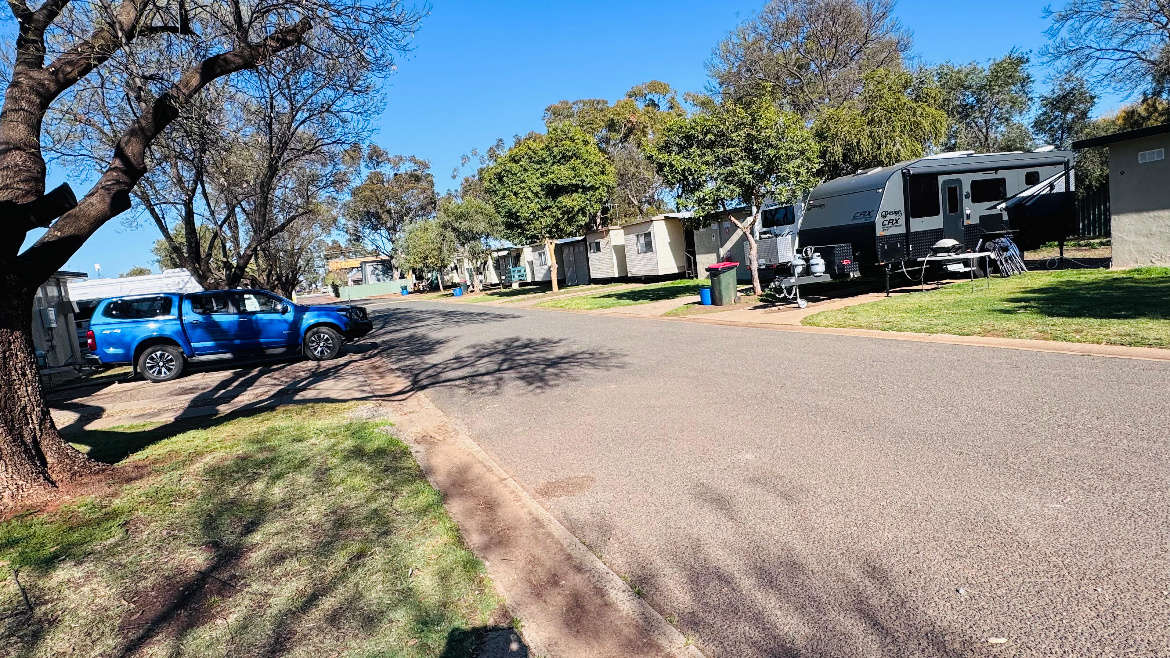Spacious drive-through powered caravan sites on grass site