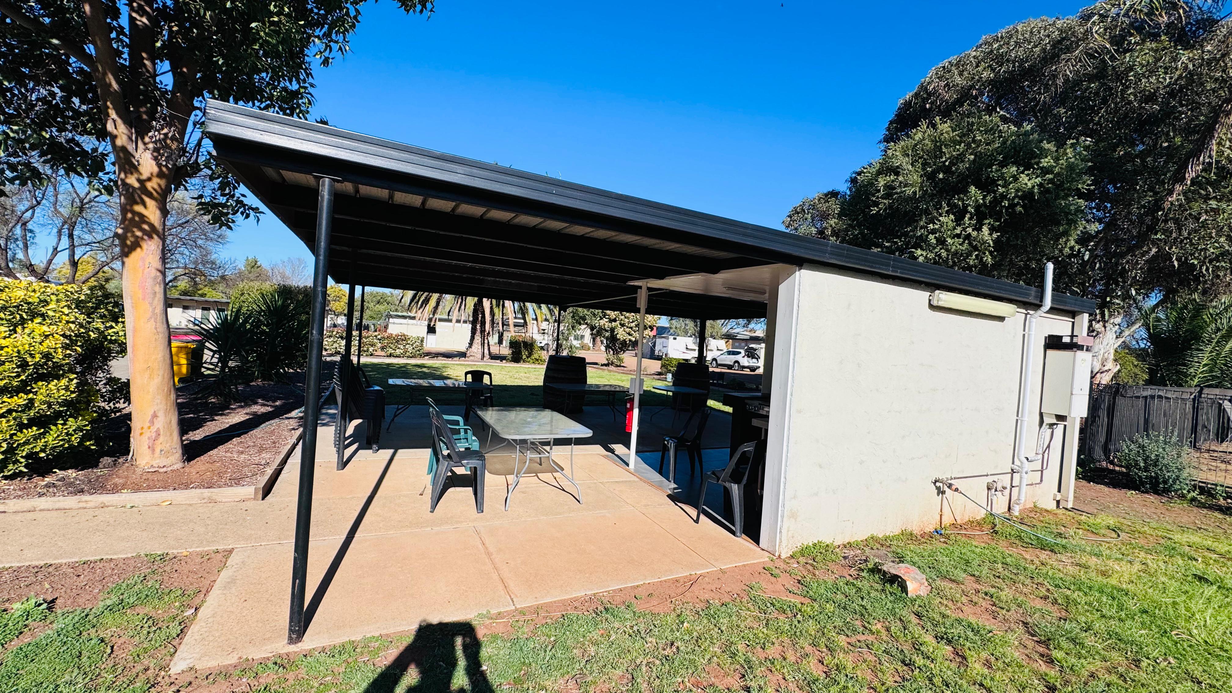 Beautiful shaded gas barbecue facilities situated alongside green lawns